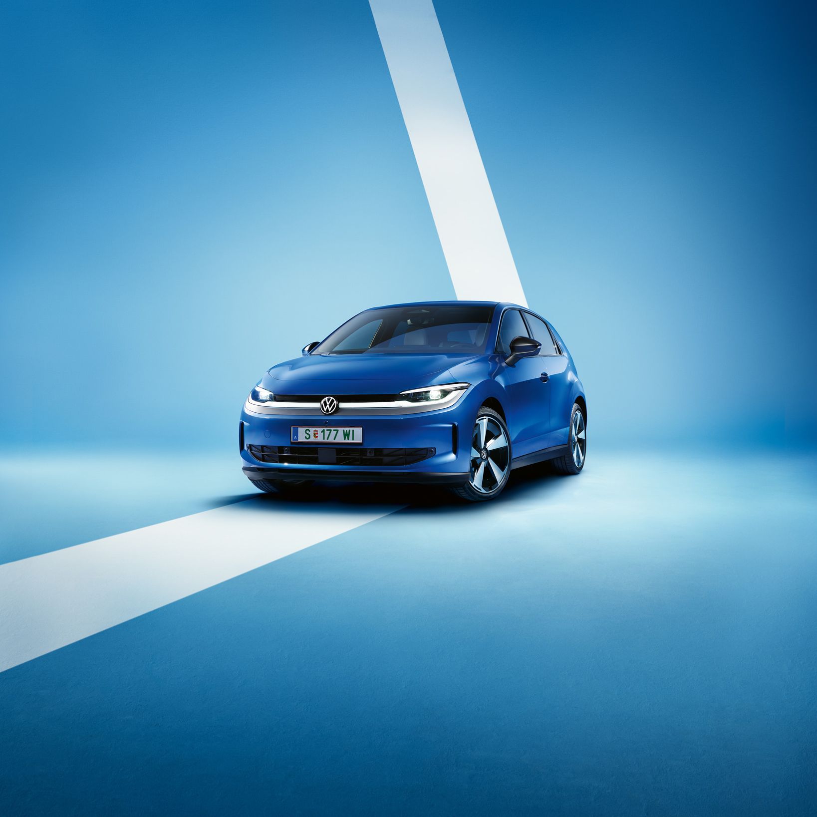 Ein blauer VW ID. Polo Style von schräg vorne vor einem hellblauen Hintergrund.